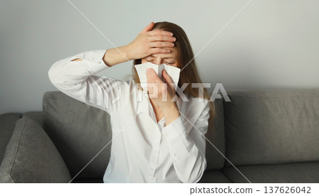 Sick exhausted young woman sneezing blow nose using tissue, unhealthy suffering girl feels unwell 137626042