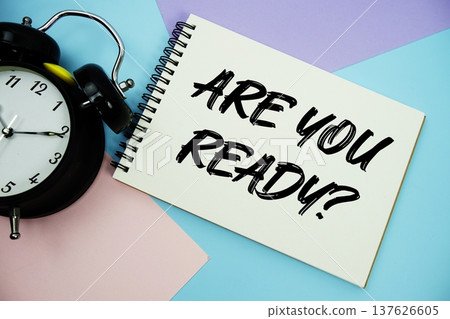 Are You Ready? text written on notepad with alarm clock flat lay on multicolor pastel background 137626605