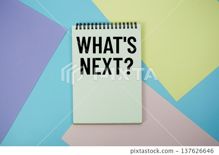 What's Next? text written on notepad flat lay on multicolor pastel background 137626646