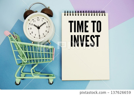 Time To Invest text written on notepad with alarm clock and trolley shopping cart 137626659