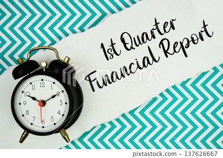 1st Quarter Financial Report text written on paper rip with alarm clock flat lay on turquoise chevron background 1st Quarter Financial Report text written on paper rip with alarm clock flat lay on turquoise chevron background 137626667