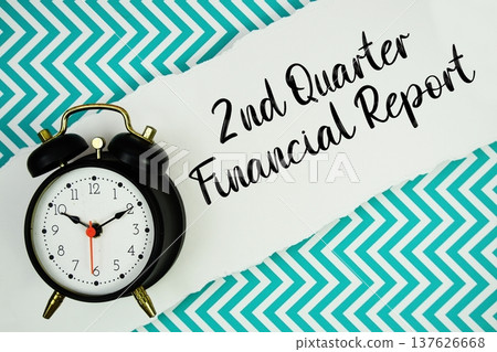 2nd Quarter Financial Report text written on paper rip with alarm clock flat lay on turquoise chevron background 2nd Quarter Financial Report text written on paper rip with alarm clock flat lay on turquoise chevron background 137626668