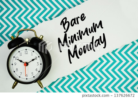 Bare Minimum Monday text written on paper rip with alarm clock flat lay on turquoise chevron background 137626672