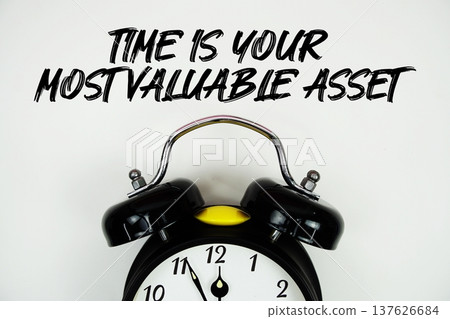 Time Is Your Most Valuable Asset text with alarm clock flat lay on white background Time Is Your Most Valuable Asset text with alarm clock flat lay on white background 137626684