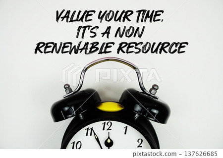 Value Your Time, It's A Non-Renewable Resource text with alarm clock flat lay on white background 137626685