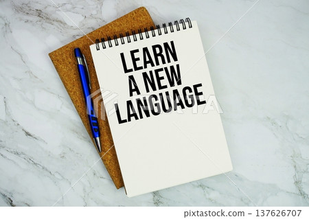 Learn A New Language text written on notepad with pen on marble background Learn A New Language text written on notepad with pen on marble background 137626707