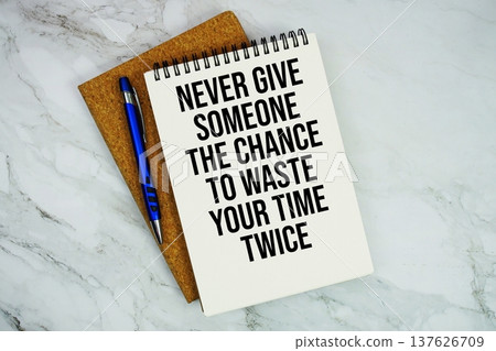 Never Give Someone The Chance To Waste Your Time Twice text written on notepad with pen on marble background Never Give Someone The Chance To Waste Your Time Twice text written on notepad with pen on marble background 137626709