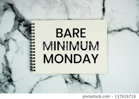 Bare Minimum Monday text written on notepad flat lay on marble background Bare Minimum Monday text written on notepad flat lay on marble background 137626719