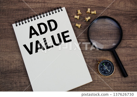 Add Value text written on notepad with compass and magnifying glass flat lay on wooden background Add Value text written on notepad with compass and magnifying glass flat lay on wooden background 137626730