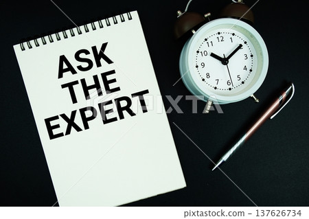 Ask The Expert text written on notepad with pen and alarm clock 137626734
