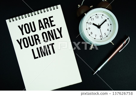 You Are Your Only Limit text written on notepad with pen and alarm clock 137626758