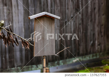 Empty retro wooden billboard in the autumn park. Signboard made of wood with space for text and graphics. 137627355