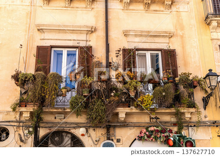 Historic italian house balcony with flowers summer Historic italian house balcony with flowers summer 137627710