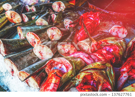 Fresh seafood in ice on counter in grocery store. Vendors display variety of sea fish. Fresh seafood in ice on counter in grocery store. Vendors display variety of sea fish. 137627761