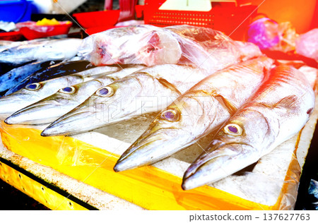 Fresh seafood in ice on counter in grocery store. Vendors display variety of sea fish. Fresh seafood in ice on counter in grocery store. Vendors display variety of sea fish. 137627763