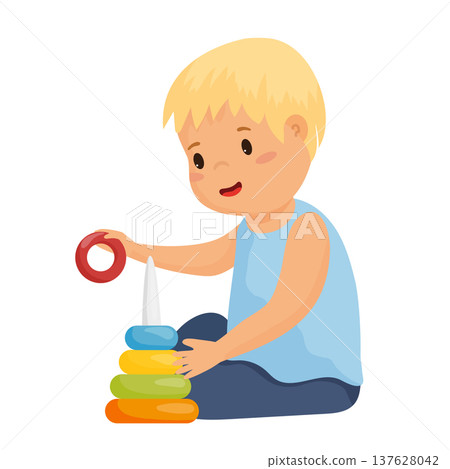 Boy Playing with a Toy Pyramid Boy Playing with a Toy Pyramid 137628042