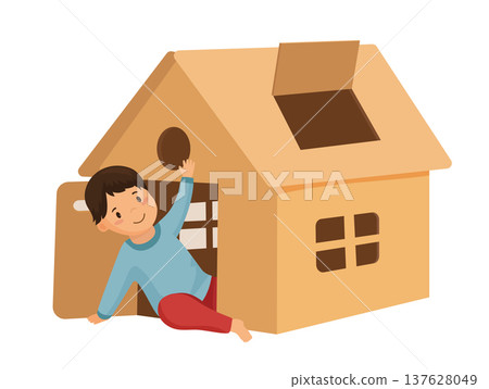 Boy Playing in a Cardboard House Boy Playing in a Cardboard House 137628049