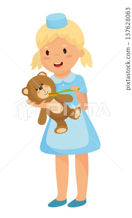 Girl Playing Nurse with Toy Bear 137628063