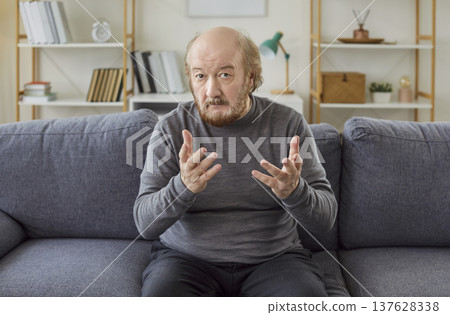 Serious Senior Man On Video Call At Home Serious Senior Man On Video Call At Home 137628338