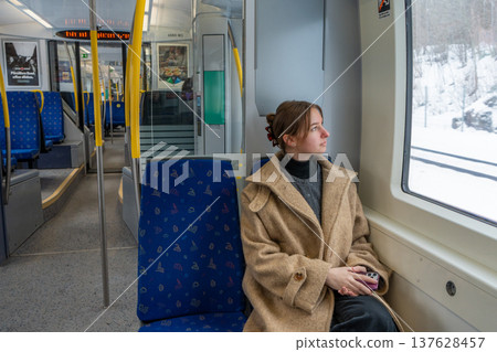 Solo Female Traveler Sitting in Train Looking Through Window.  137628457