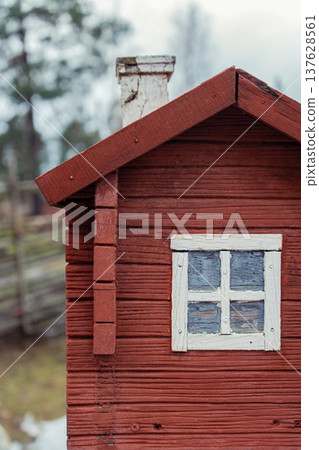 Red Wooden Cabin With White Window Detail. 137628561