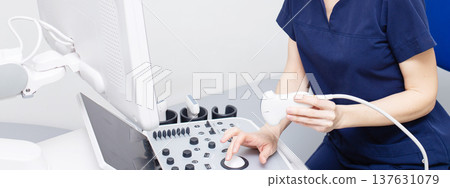 Female doctor sitting in office in a hospital doing ultrasound scanning diagnostic 137631079