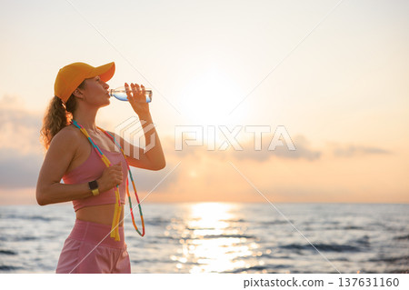 Fit woman jumping rope at the beach during summer vacation 137631160