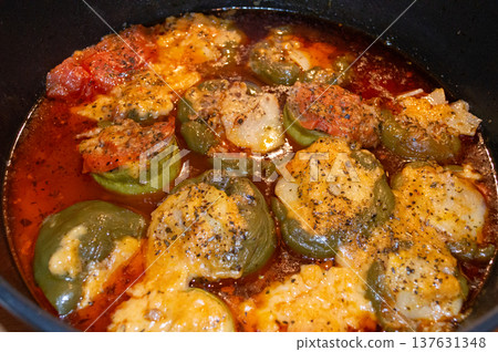 Stuffed Green Peppers in Tomato Sauce with Melted Cheese 137631348