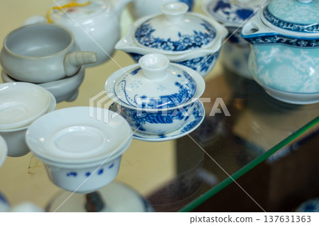 Blue and white porcelain tea set on glass table Blue and white porcelain tea set on glass table 137631363