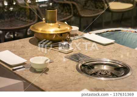 Hot pot table setting with brass pot and built-in burner 137631369