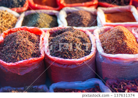 Colorful ground spices in sacks at outdoor market Colorful ground spices in sacks at outdoor market 137631374