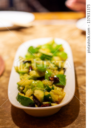 Spicy cucumber salad appetizer in white dish Spicy cucumber salad appetizer in white dish 137631375