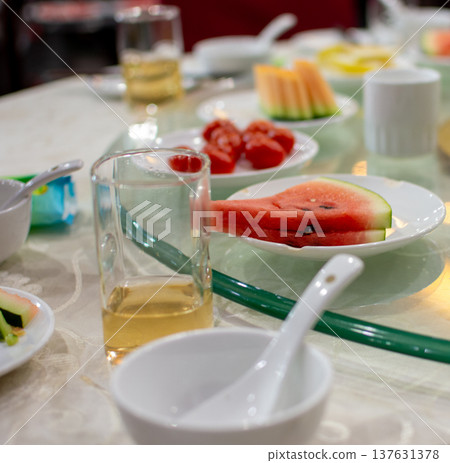 Dining table with fresh fruit plates and tea glasses 137631378