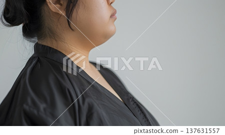Profile of a chubby woman's neck in a black gown 137631557