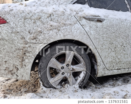 White car is splashed with mud from the road. The whole car is dirty White car is splashed with mud from the road. The whole car is dirty 137631581