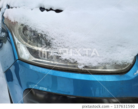 Blue car covered in white snow 137631590