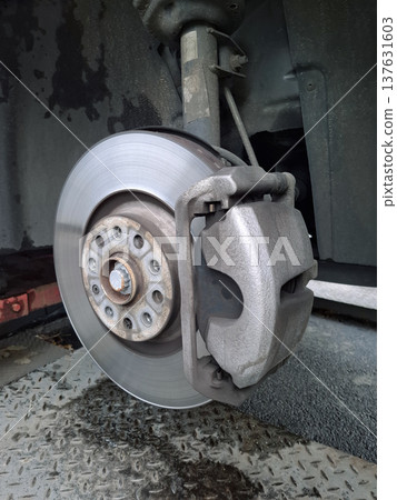 Car at service station. Wheel disassembly and repair. Brake disc and brake pads Car at service station. Wheel disassembly and repair. Brake disc and brake pads 137631603