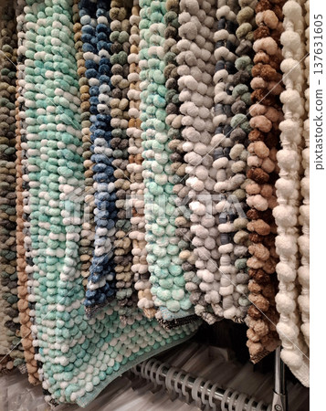 Small soft rugs hanging in shop 137631605