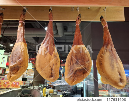 Cows legs are sold in meat department of shop. Dried, smoked and salted meat Cows legs are sold in meat department of shop. Dried, smoked and salted meat 137631608