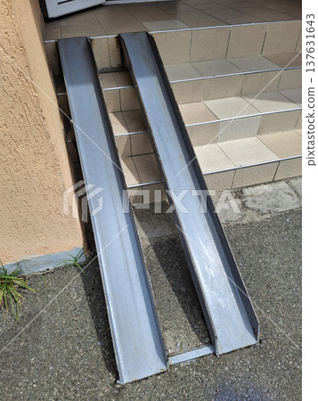 Metal entry ramp for strollers at the front entrance 137631643