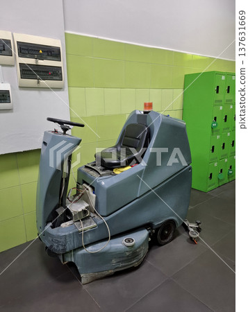 Self-propelled floor scrubber with operator seat. Ride-on floor scrubber machine Self-propelled floor scrubber with operator seat. Ride-on floor scrubber machine 137631669