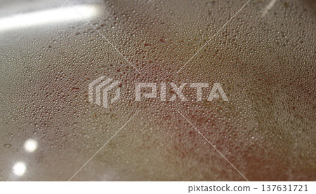 Small bubbles condense on the lid inside the pan with hot food Small bubbles condense on the lid inside the pan with hot food 137631721