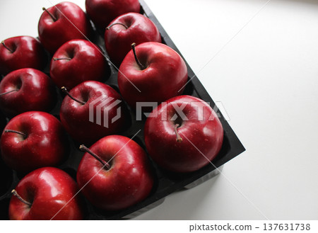 Juicy Red Apples Inside Compartments Of Storage Case For Fruits  137631738