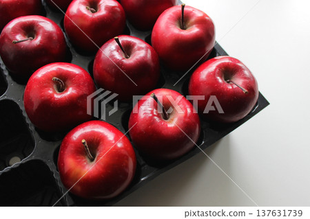 Perfect Red Apple Fruits In Separated Places Of Black Plastic Box  137631739
