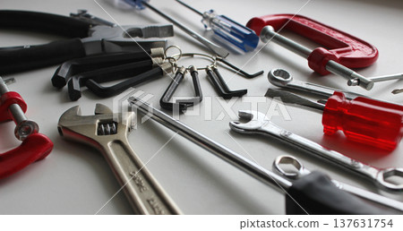Variety Colors Pliers, Wrenches, Spanners, Screwdrivers, Clamps And Hex Keys Disorderly Scattered Closeup Angle View Variety Colors Pliers, Wrenches, Spanners, Screwdrivers, Clamps And Hex Keys Disorderly Scattered Closeup Angle View 137631754