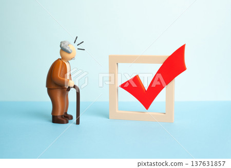 An elderly man and a red voting checkmark. Elections or referendums with assistance for immobile voters. Democratic participation supported through accessibility and social inclusion programs. 137631857