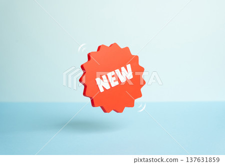 A New sticker levitating on a blue background. Symbol of new products and services entering the market. Marketing promotion highlights innovation, product launches and fresh commercial opportunities. A New sticker levitating on a blue background. Symbol of new products and services entering the market. Marketing promotion highlights innovation, product launches and fresh commercial opportunities. 137631859