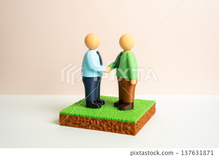 An agreement to purchase or sell a plot of land. Two parties enter into a transaction and sign legal documents. Real estate deal, property transfer and formal contract between buyer and seller. 137631871