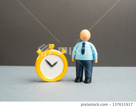 An office worker with a stopwatch. Concept of work schedules and standardized working hours. Time management, overtime payments and temporary employment in modern corporate life. 137631917