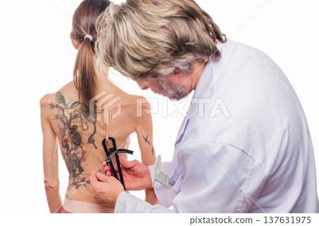 Doctor measuring woman's skin fold for body composition Doctor measuring woman's skin fold for body composition 137631975
